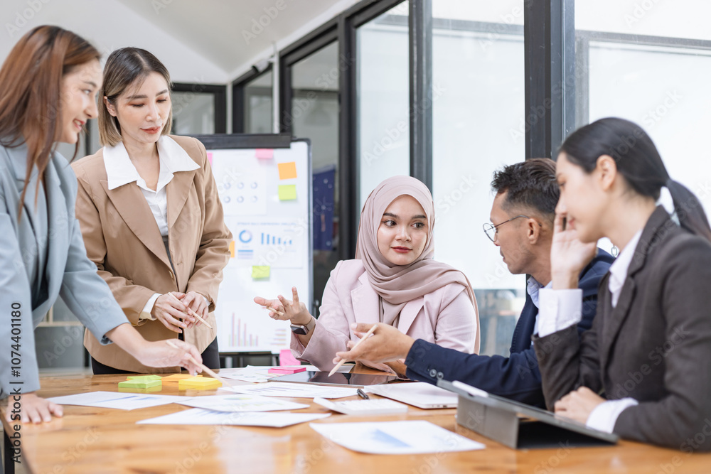 Team of Asian business people and working together in office, Startup projects and business presentation at meeting room. Team of Asian business people and working together in office, Startup projects and business presentation at meeting room.