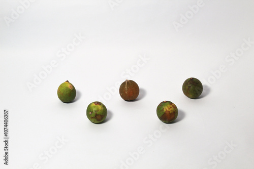 Green lime fruits on isolated white background. Sliced and unsliced. photo