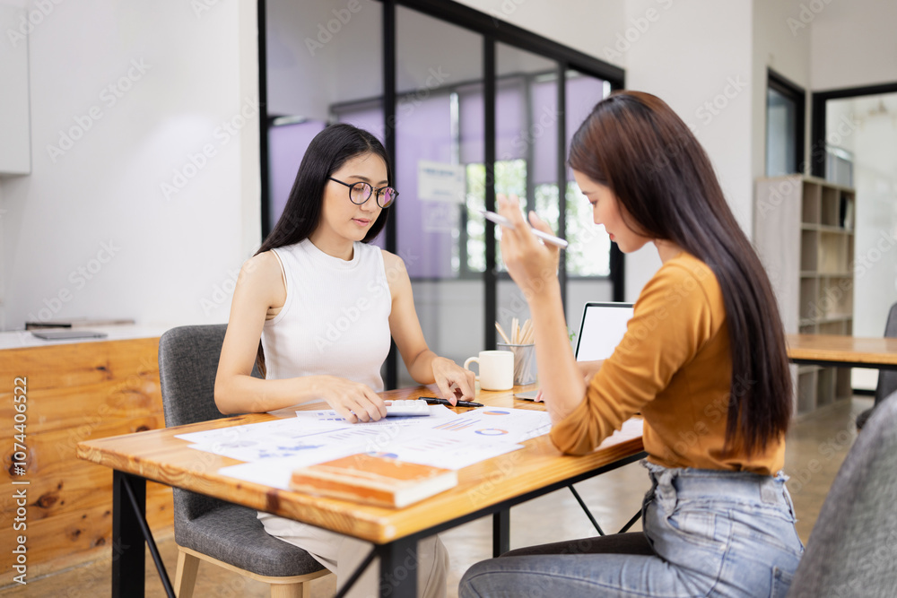 young asian businesswoman working on laptop with finances analysis report at desk in office, business financing, accounting banking, young asian businesswoman working on laptop with finances analysis report at desk in office, business financing, accounting banking,