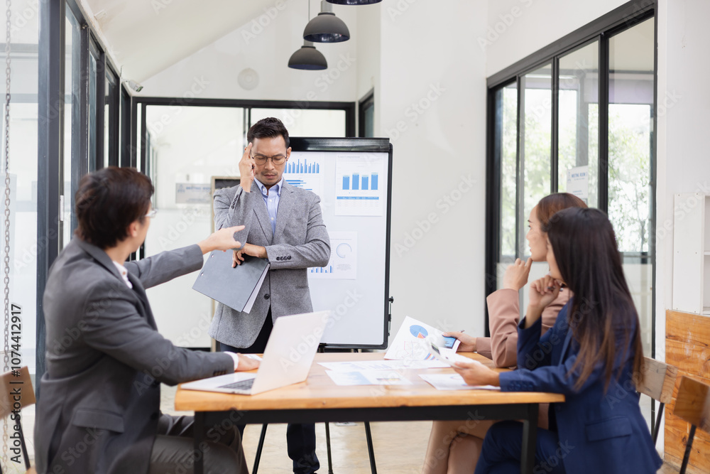 © SOMKID - Asian business teamwork working with analysis report and advisor showing plan, Financial analysis and Marketing teamwork concept.