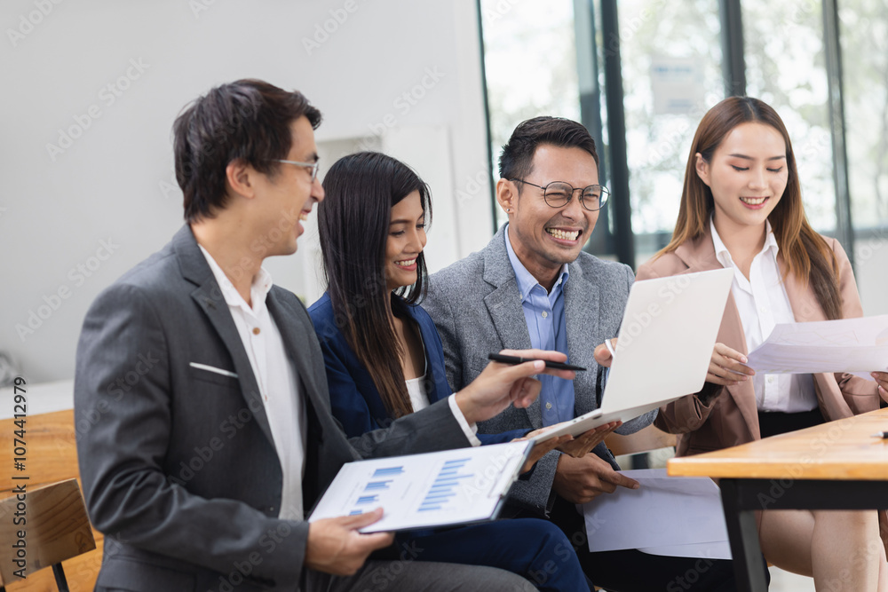 Asian business teamwork working with analysis report and advisor showing plan, Financial analysis and Marketing teamwork concept. Asian business teamwork working with analysis report and advisor showing plan, Financial analysis and Marketing teamwork concept.