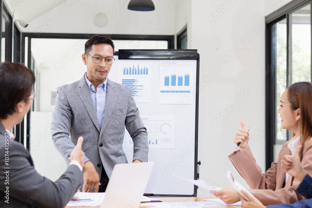 Asian business teamwork working with analysis report and advisor showing plan, Financial analysis and Marketing teamwork concept. Asian business teamwork working with analysis report and advisor showing plan, Financial analysis and Marketing teamwork concept.