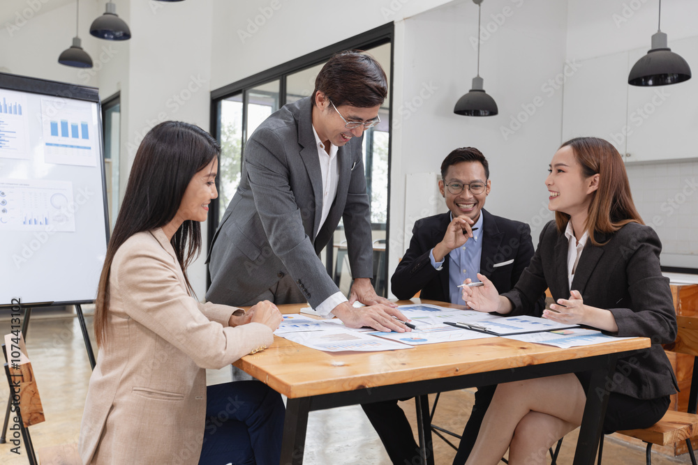 Asian business teamwork working with analysis report and advisor showing plan, Financial analysis and Marketing teamwork concept. Asian business teamwork working with analysis report and advisor showing plan, Financial analysis and Marketing teamwork concept.