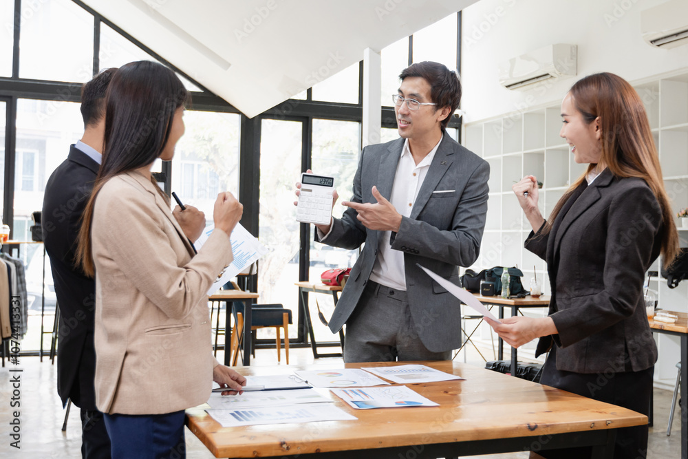 Asian business teamwork working with analysis report and advisor showing plan, Financial analysis and Marketing teamwork concept. Asian business teamwork working with analysis report and advisor showing plan, Financial analysis and Marketing teamwork concept.