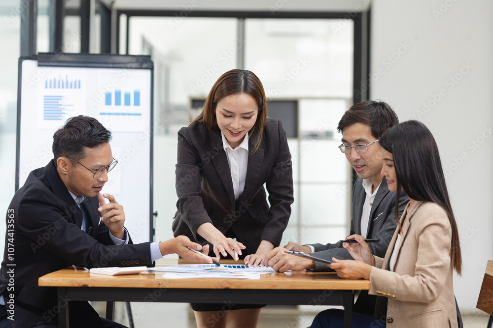 Asian business teamwork working with analysis report and advisor showing plan, Financial analysis and Marketing teamwork concept. Asian business teamwork working with analysis report and advisor showing plan, Financial analysis and Marketing teamwork concept.