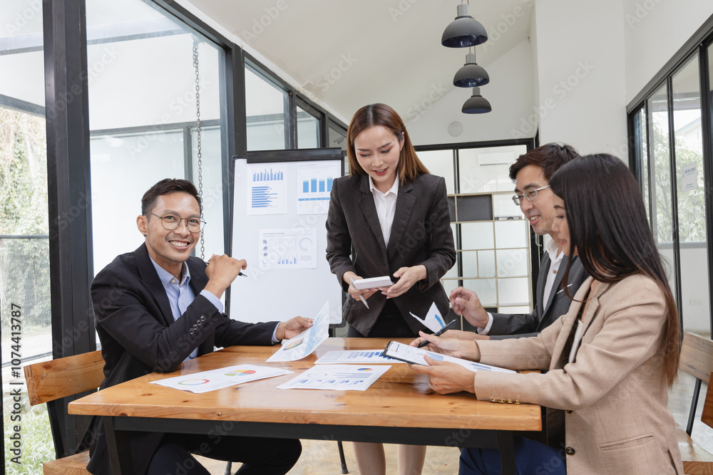 Asian business teamwork working with analysis report and advisor showing plan, Financial analysis and Marketing teamwork concept. Asian business teamwork working with analysis report and advisor showing plan, Financial analysis and Marketing teamwork concept.