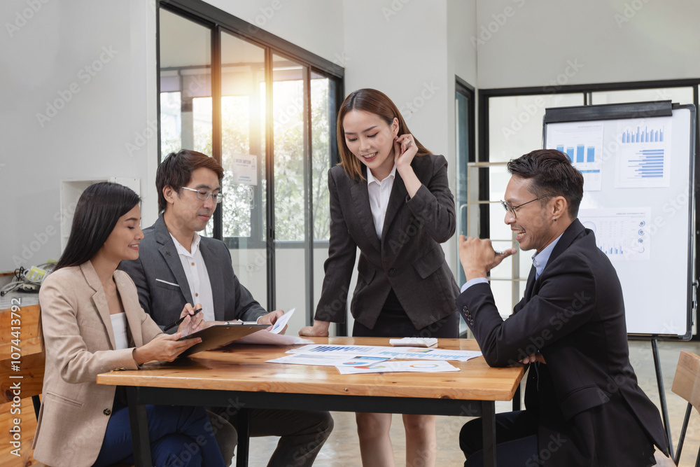 Asian business teamwork working with analysis report and advisor showing plan, Financial analysis and Marketing teamwork concept. Asian business teamwork working with analysis report and advisor showing plan, Financial analysis and Marketing teamwork concept.