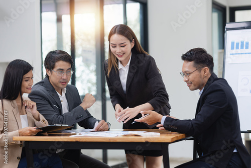 Asian business teamwork working with analysis report and advisor showing plan, Financial analysis and Marketing teamwork concept.