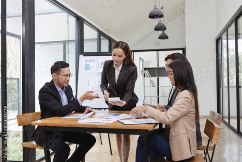 Asian business teamwork working with analysis report and advisor showing plan, Financial analysis and Marketing teamwork concept.