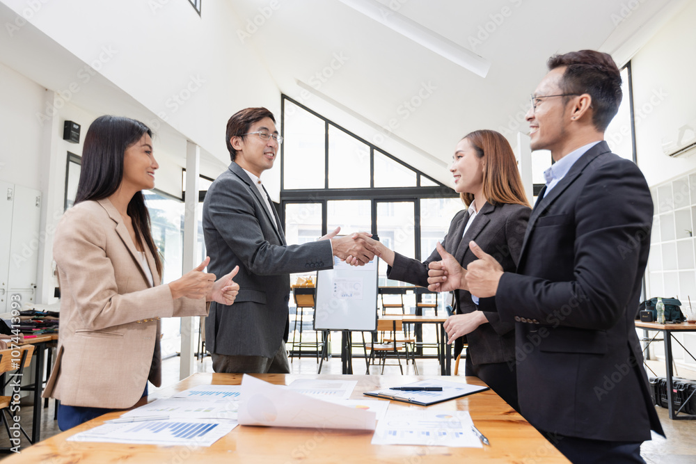 Asian business teamwork working with analysis report and advisor showing plan, Financial analysis and Marketing teamwork concept. Asian business teamwork working with analysis report and advisor showing plan, Financial analysis and Marketing teamwork concept.