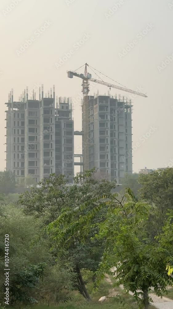 Air Pollution and construction. Construction building with crane in smoggy environment. Fog and Smog because of building construction in Islamabad, Pakistan. Construction and air pollution. 