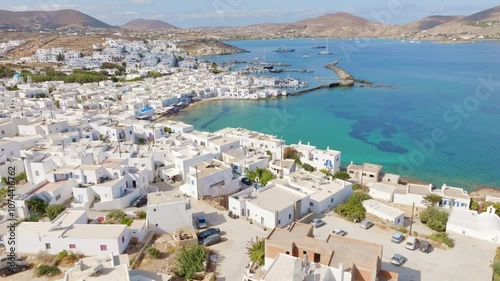 Drone shot of Naoussa, a picturesque coastal town on Paros Island, showcasing its charming harbor, traditional Cycladic architecture, and the turquoise Aegean Sea