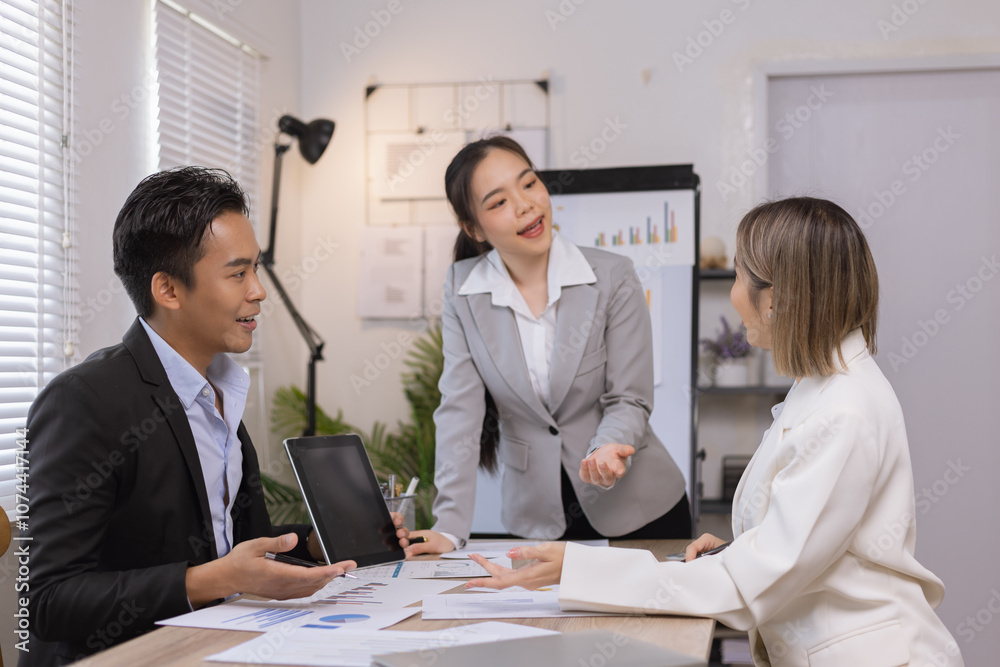 Fototapeta premium Asian business team working with analysis report and advisor showing plan, Financial analysis and Marketing teamwork concept.