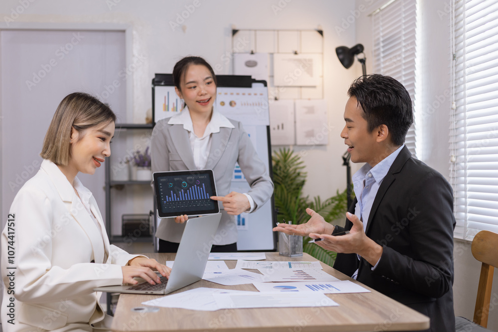 Asian business teamwork working on digital tablet with analysis report and advisor showing plan, Financial analysis and Marketing teamwork concept. Asian business teamwork working on digital tablet with analysis report and advisor showing plan, Financial analysis and Marketing teamwork concept.