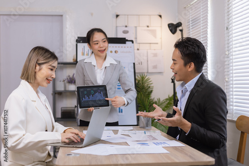 Asian business teamwork working on digital tablet with analysis report and advisor showing plan, Financial analysis and Marketing teamwork concept.