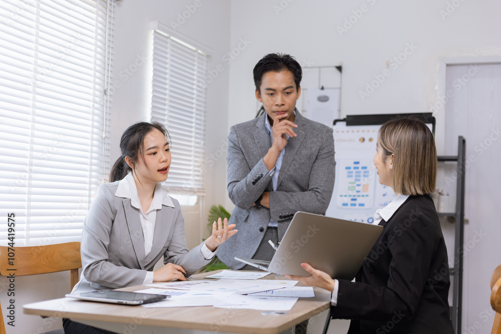 Asian business teamwork working on digital tablet with analysis report and advisor showing plan, Financial analysis and Marketing teamwork concept. Asian business teamwork working on digital tablet with analysis report and advisor showing plan, Financial analysis and Marketing teamwork concept.