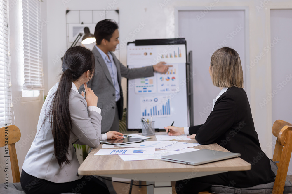 Asian business teamwork working on digital tablet with analysis report and advisor showing plan, Financial analysis and Marketing teamwork concept. Asian business teamwork working on digital tablet with analysis report and advisor showing plan, Financial analysis and Marketing teamwork concept.