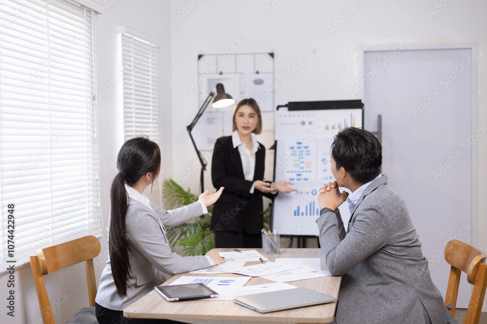 Asian business teamwork working on digital tablet with analysis report and advisor showing plan, Financial analysis and Marketing teamwork concept. Asian business teamwork working on digital tablet with analysis report and advisor showing plan, Financial analysis and Marketing teamwork concept.