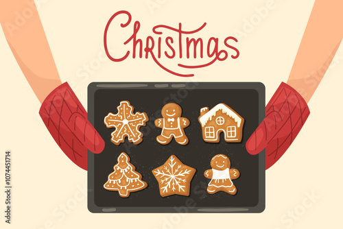Hands in oven mitts holding a baking tray with hot gingerbread Christmas cookies. Christmas text