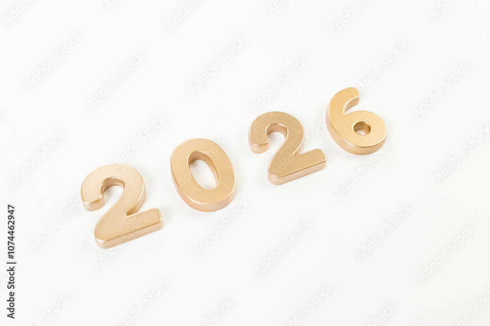 2026 Happy New Year. Top view of gold numbers on white background. Copy space, flat lay. 2026 Happy New Year. Top view of gold numbers on white background. Copy space, flat lay.