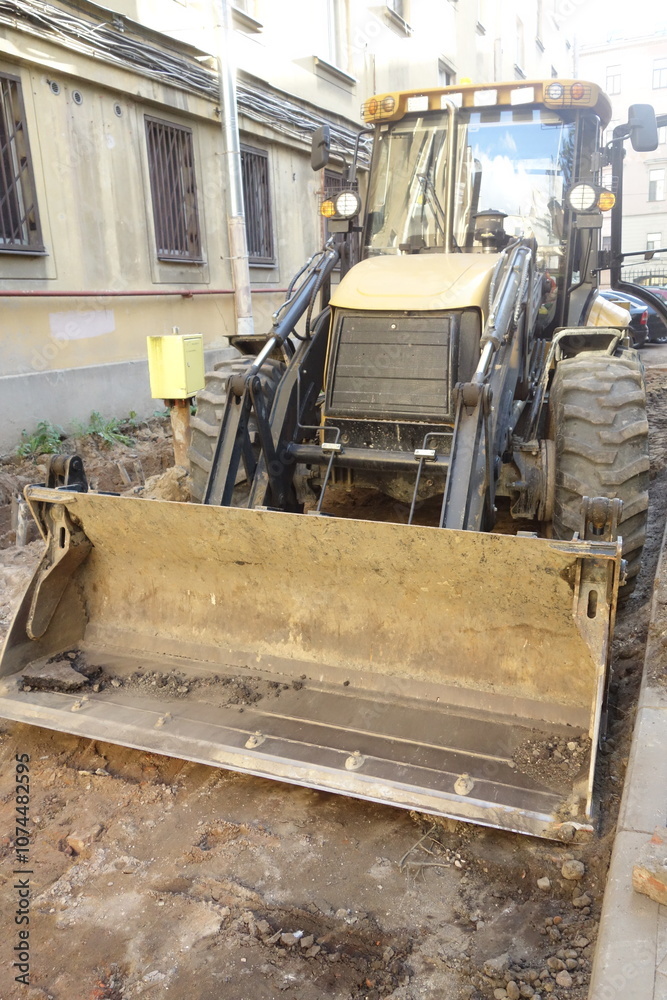 Fototapeta premium excavator loading a truck on the yard 