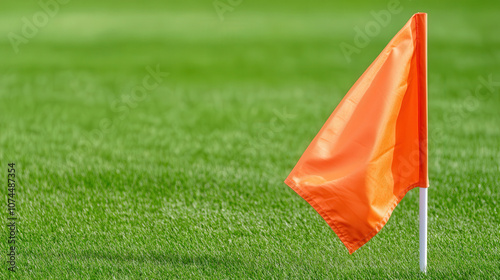 orange flag stands in corner of soccer stadium, symbolizing game. vibrant color contrasts with lush green grass, creating striking visual photo