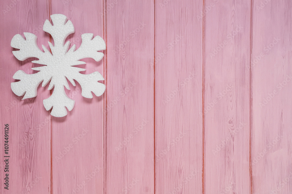 White decorative snowflakes on pink wooden background, copy space White decorative snowflakes on pink wooden background, copy space
