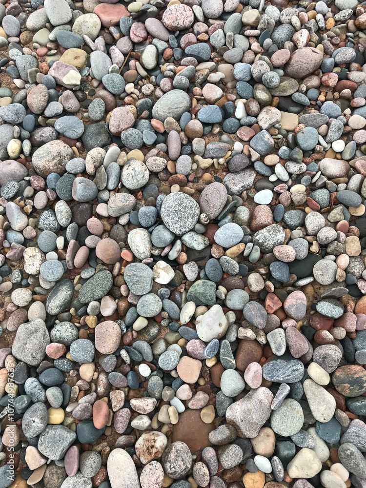 Rock Beach. Round, jagged smooth and textured pebbles, rocks, and stones. Light dark gray slate. Background, landscape. Close up Rock Beach. Round, jagged smooth and textured pebbles, rocks, and stones. Light dark gray slate. Background, landscape. Close up