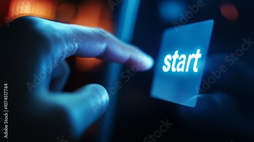 A person is pointing to the start button on a device photo