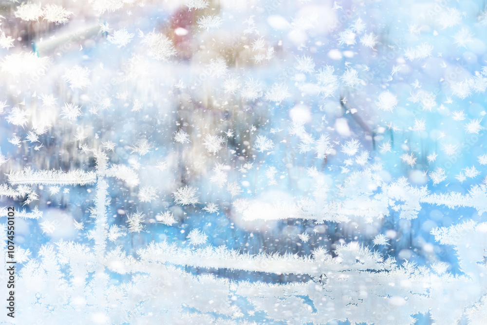 Winter landscape through a frozen window. Blurred snow background. Trees and plants covered with snow. Winter landscape through a frozen window. Blurred snow background. Trees and plants covered with snow.