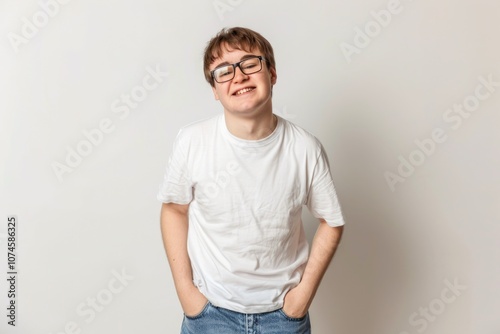 A portrait of a young adult with glasses and a plain white t-shirt, ideal for use in editorial or personal contexts