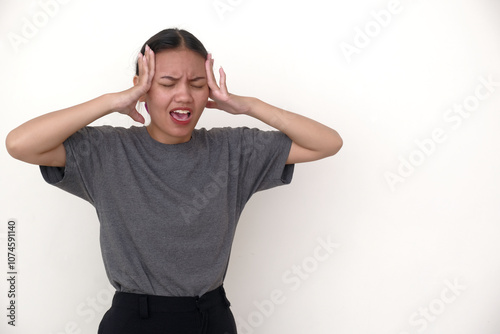 A woman held her head in both hands, with an expression of pain photo