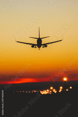 Airplane landing on the runway during sunset and night