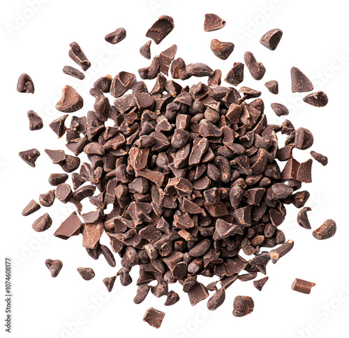 A pile of dark chocolate chips scattered. The chips are various sizes and shapes.