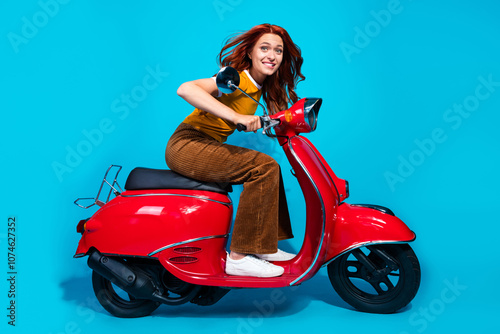 Photo of funny cheerful positive woman wear stylish clothes drive motorcycle isolated on blue color background photo