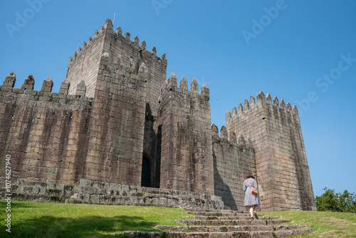 Tourist walking to the historic medieval Guimaraes castle in Portugal