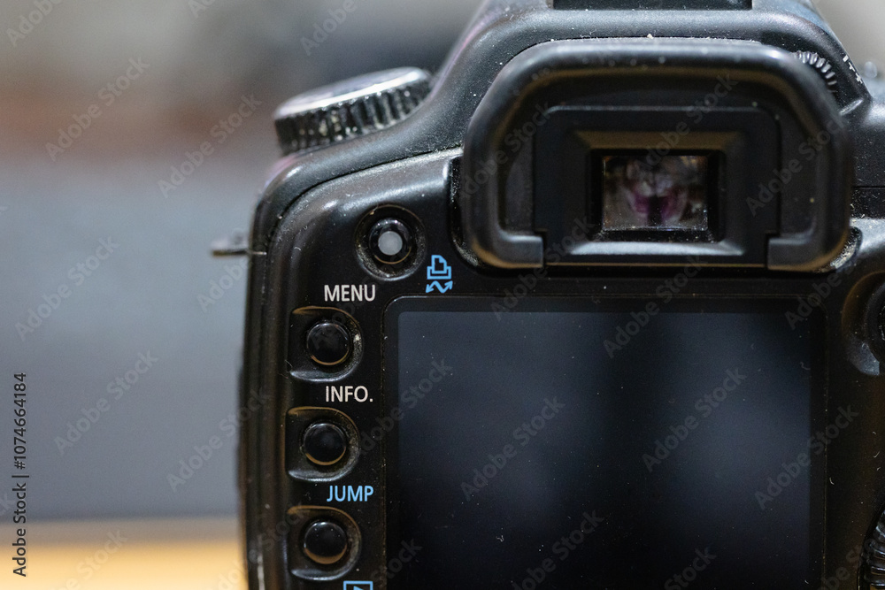 Dusty DSLR Digital single-lens reflex camera with menu, jump and playback button. view finder and lcd screen. Old photography gear. Dusty DSLR Digital single-lens reflex camera with menu, jump and playback button. view finder and lcd screen. Old photography gear.
