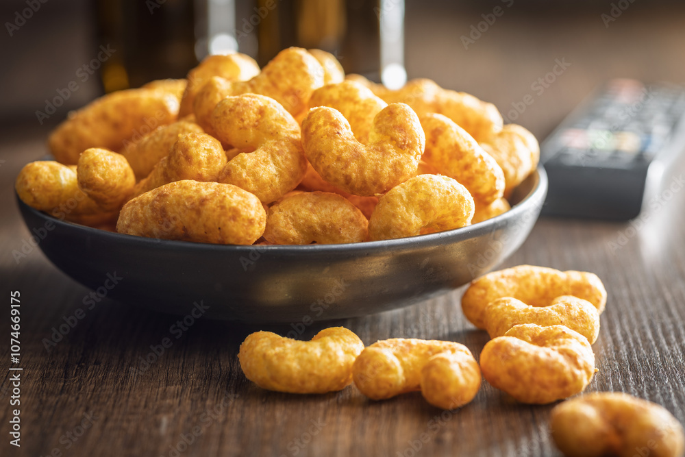 Puffed crispy Peanut flips on plate on wooden table.