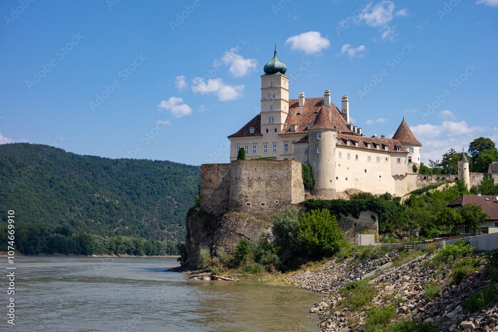 Rock with Pfarrkirche Schonbuhel church and cloister in Austria above Donau