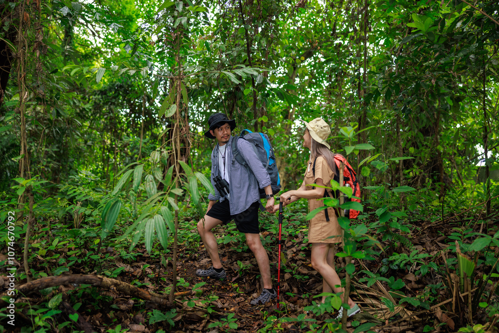 young asian couple backpacker travel in forest wild together. Attractive man and woman traveler walking and exploring nature wood with happiness and fun during holiday vacation trip young asian couple backpacker travel in forest wild together. Attractive man and woman traveler walking and exploring nature wood with happiness and fun during holiday vacation trip