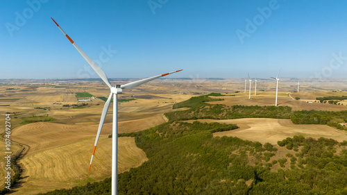 Aerial view of many wind turbines in the countryside. Clean energy concept.