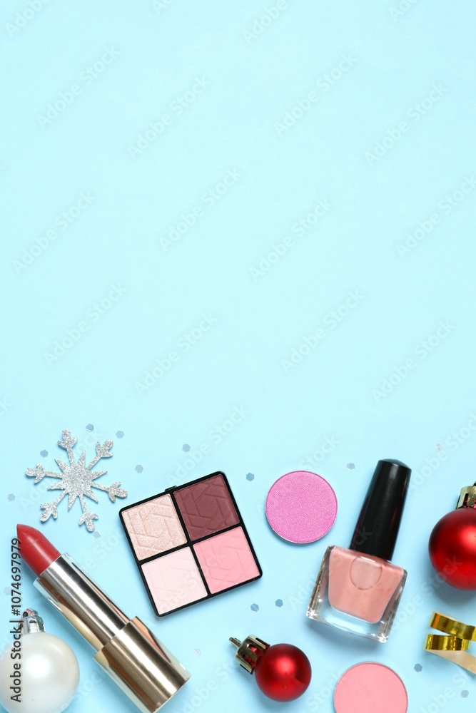 Flat lay composition with makeup products and Christmas decor on color background Flat lay composition with makeup products and Christmas decor on color background