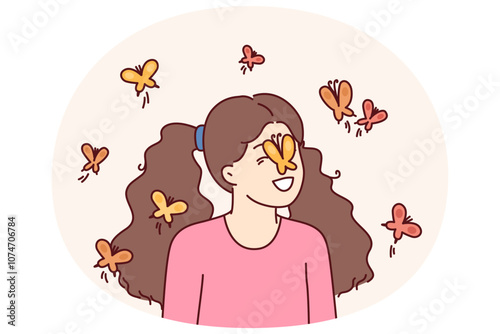 Little girl among butterflies flying and landing on face for spring mood concept. Happy childhood of preteen girl loving animals and laughing at sight of butterflies in summer park