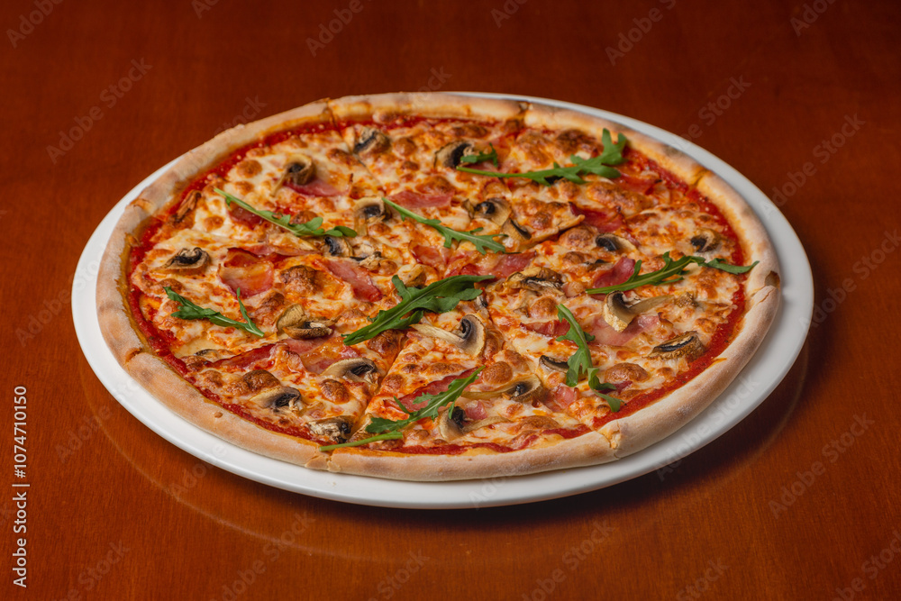 Italian pizza with mushrooms and bacon on a plate on a wooden background