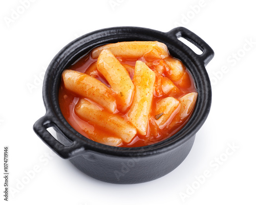 Tteokbokki rice cakes with chilli sauce isolated on white background. Korean cuisine dish. photo