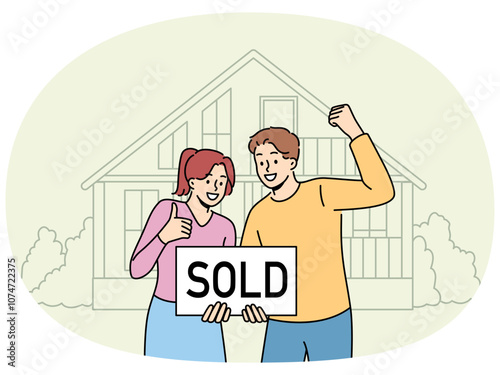 Happy couple is standing near house with inscription sold, rejoicing in sale of real estate at bargain price. Satisfied man and woman rejoice in profitable real estate deal and make victory gestures