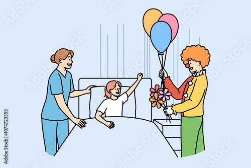 Clown entertains sick girl lying in bed in hospital to improve mood child suffering from illness. Animator gives flowers and balloons to patient at children hospital in need of psychological support