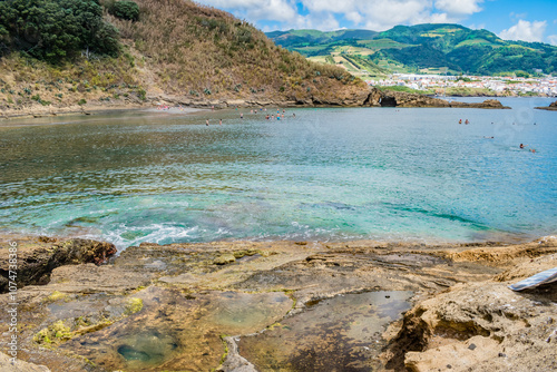 Lagoon with silhouettes of people swimming inside the islet D Vila Franca do Campo, São Miguel - Azores PORTUGAL