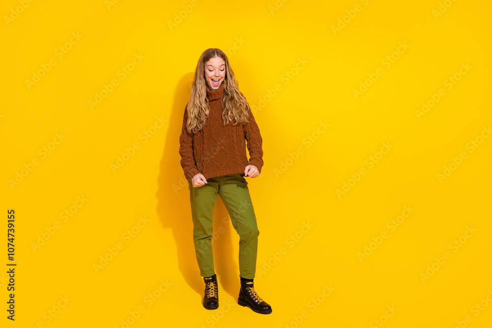 Fototapeta premium Full body portrait of nice young girl show sweater empty space isolated on yellow color background