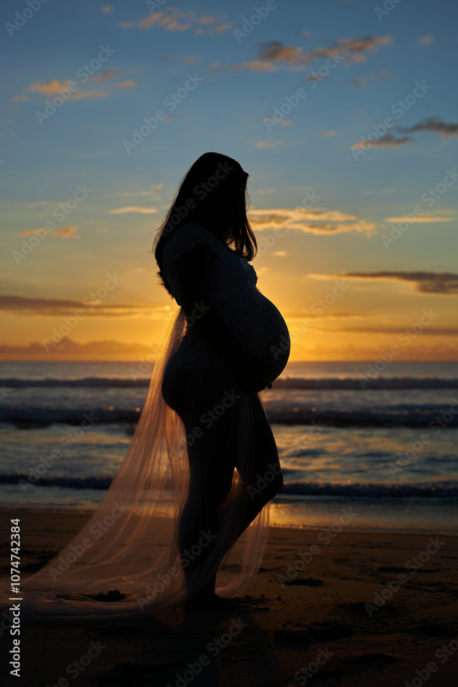 Maternity shoot at sunrise or sunset, pregnant woman on the beach relaxing on the beachside next to the surf and waves. Very pregnant expecting mother, due very soon. Maternity shoot at sunrise or sunset, pregnant woman on the beach relaxing on the beachside next to the surf and waves. Very pregnant expecting mother, due very soon.